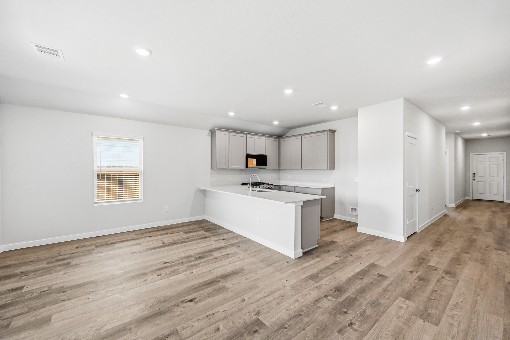 A kitchen with white cabinets.