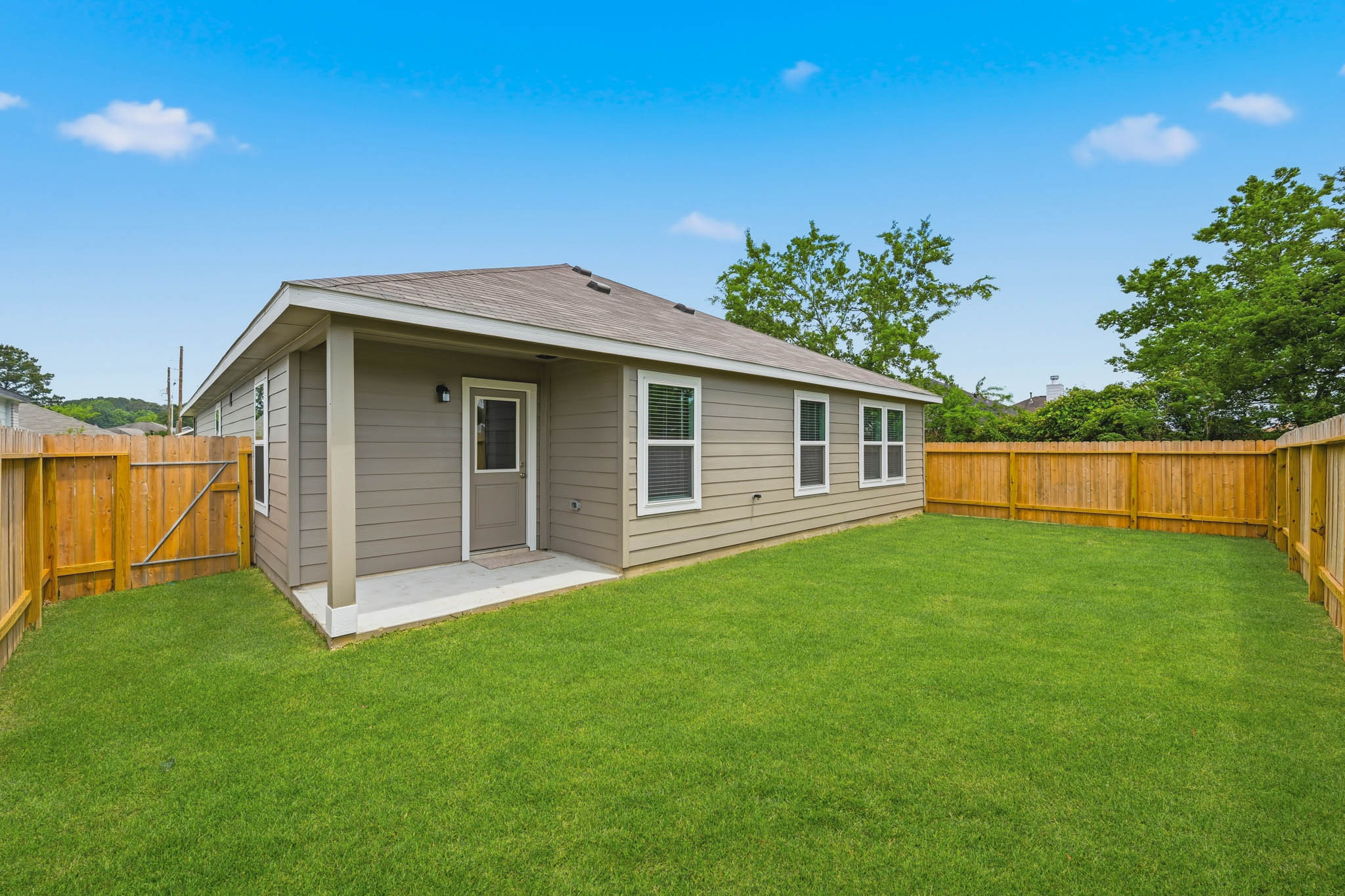 A house with a fence and grass.