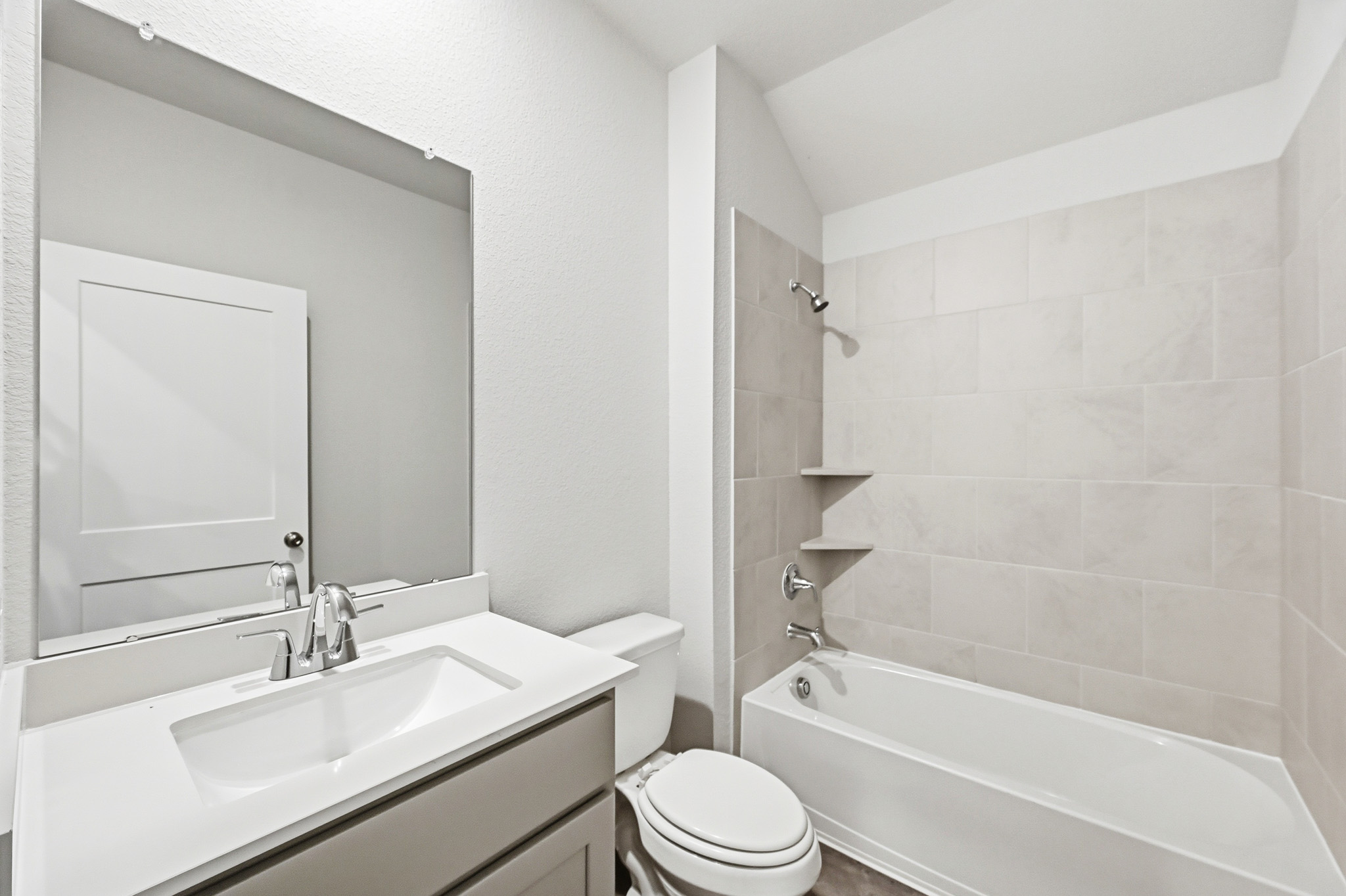A bathroom with a sink toilet and bathtub.