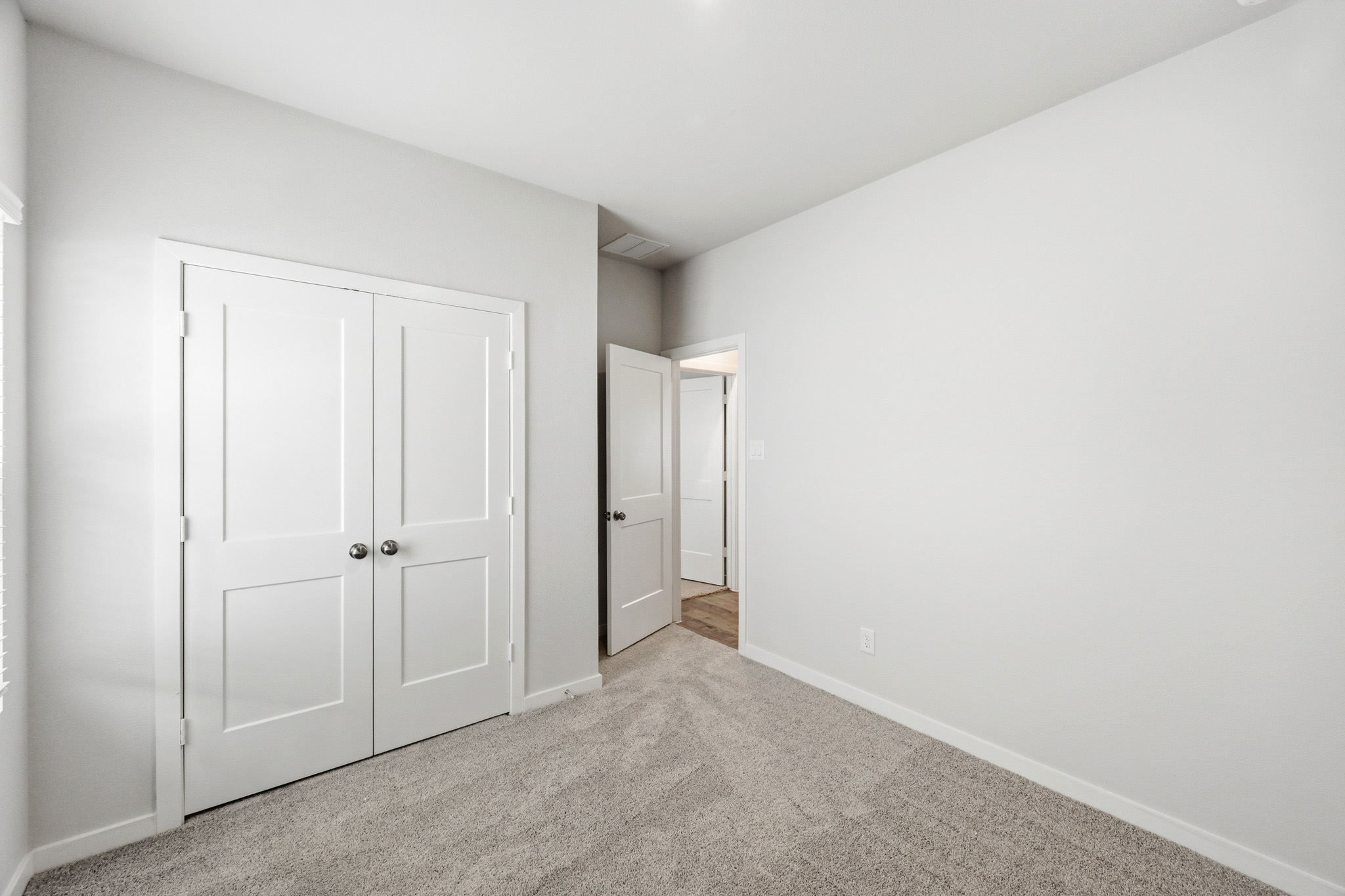 A hallway with white doors.