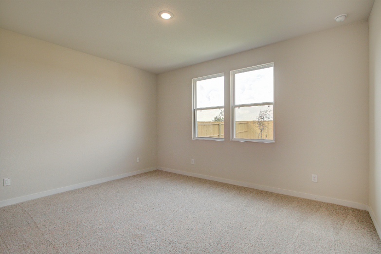 A room with a window and a carpet.