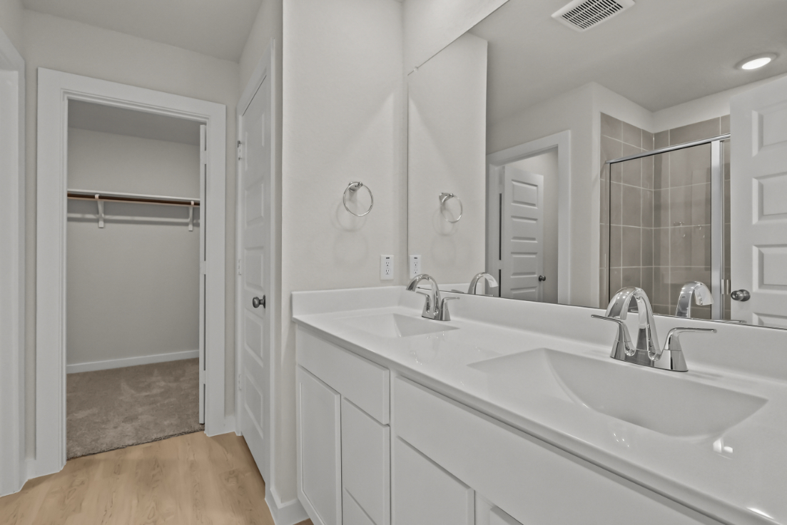 A bathroom with a large mirror.