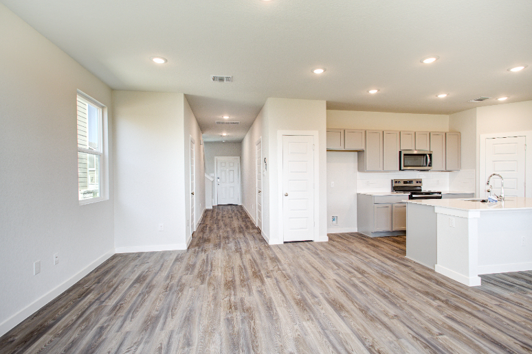 A kitchen with white cabinets.