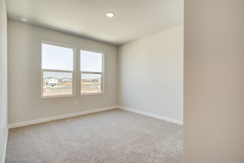 A room with a window and a carpet.