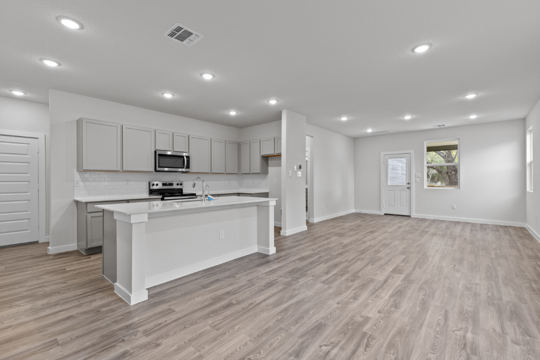 A kitchen with white cabinets.
