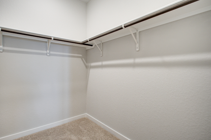 A white wall with a metal railing.