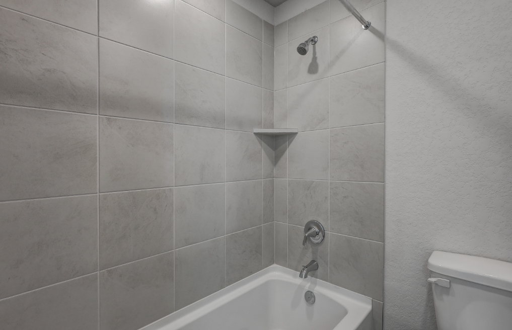 A bathroom with a bathtub and toilet.