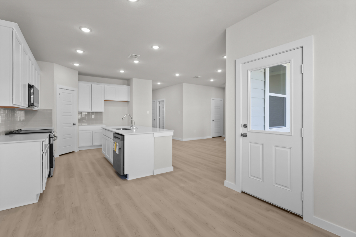 A kitchen with white cabinets.