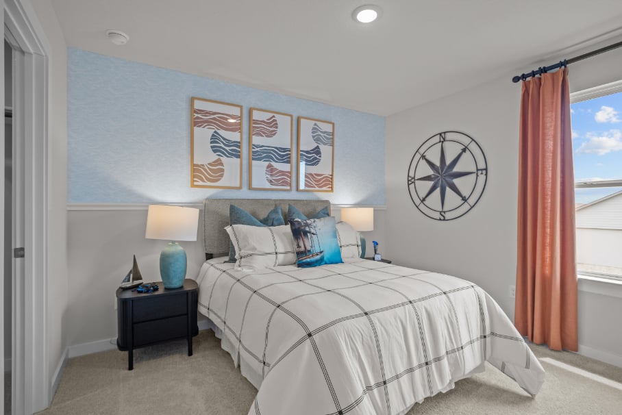 A bedroom with a bed and a lamp.