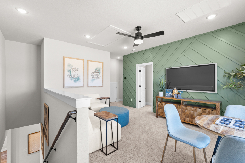 A room with a tv and chairs.