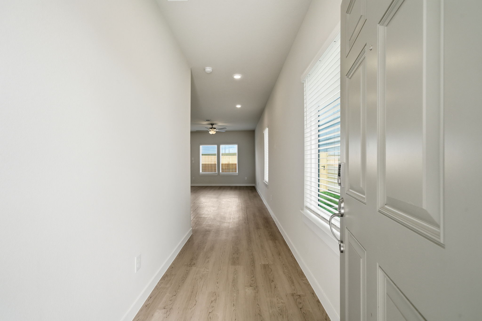 A hallway with white walls.
