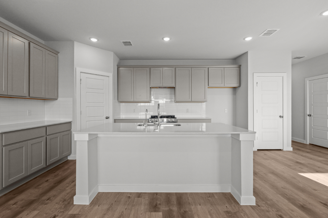 A kitchen with white cabinets.