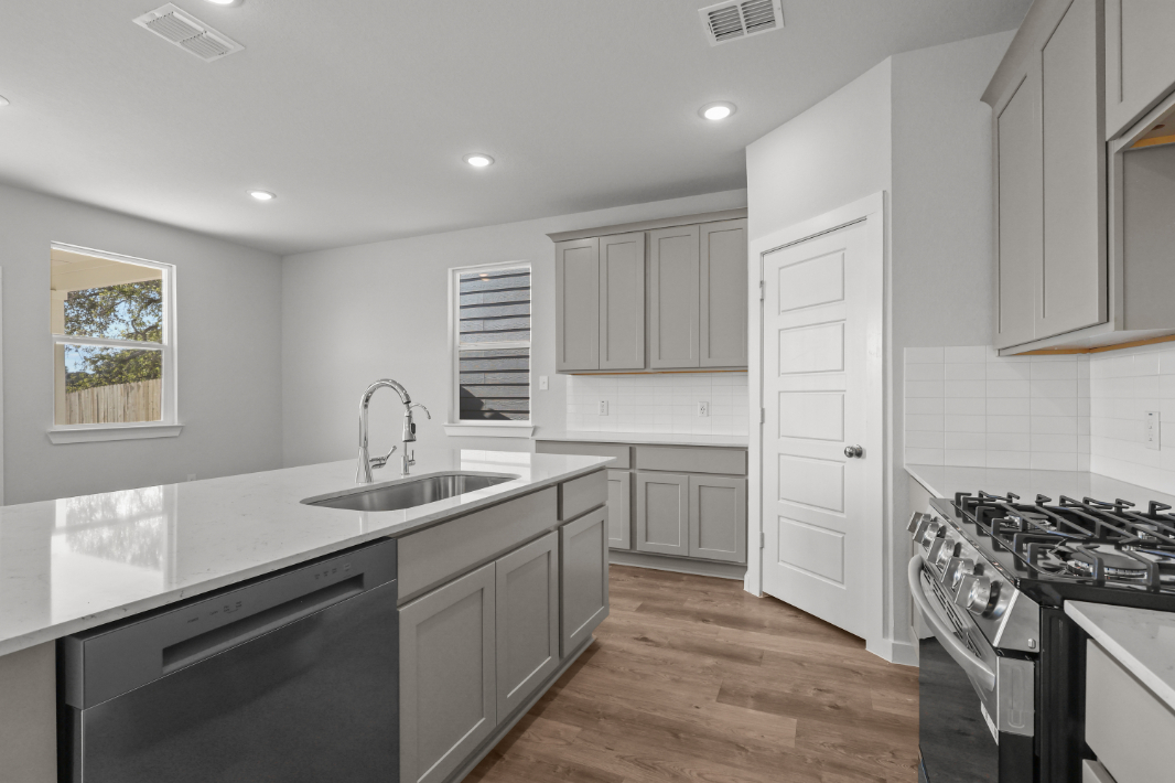 A kitchen with white cabinets.