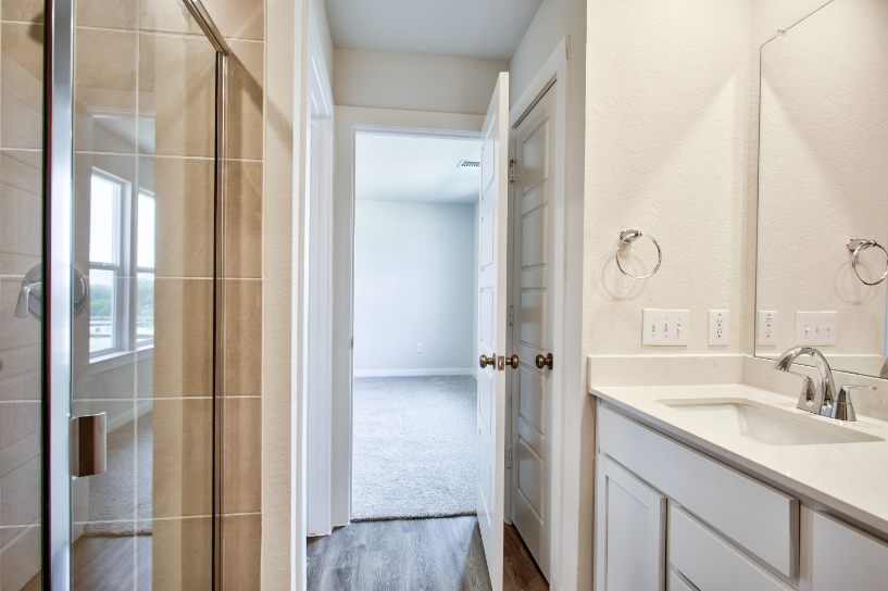 A bathroom with a sink and shower.
