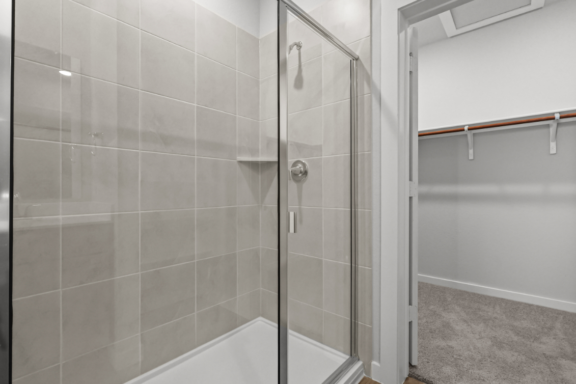 A shower with a glass door.