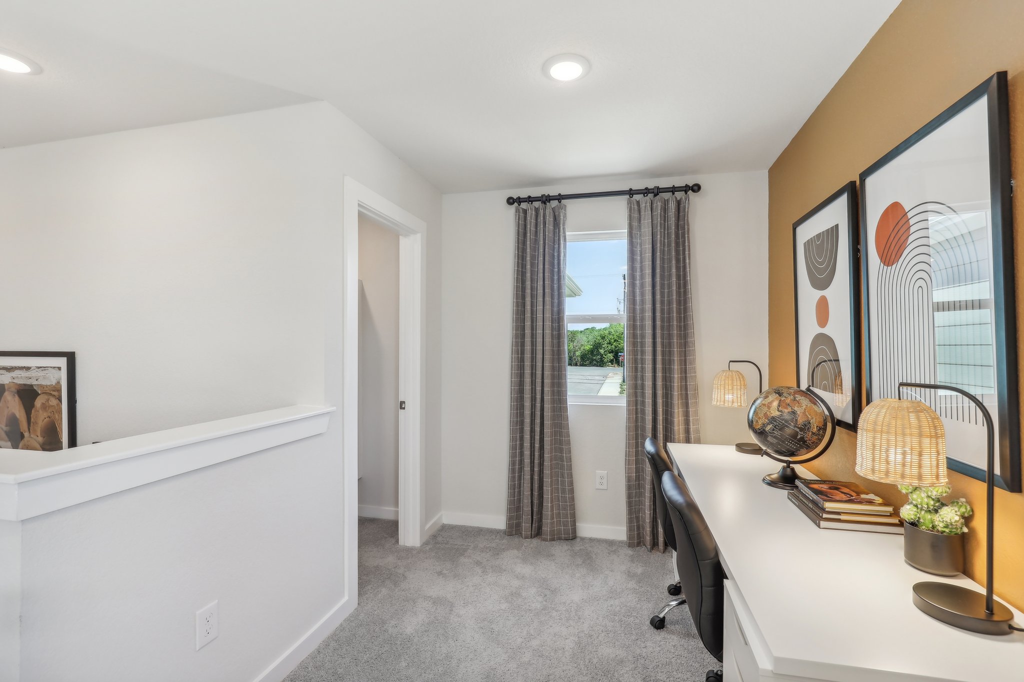 A room with a desk and a mirror.