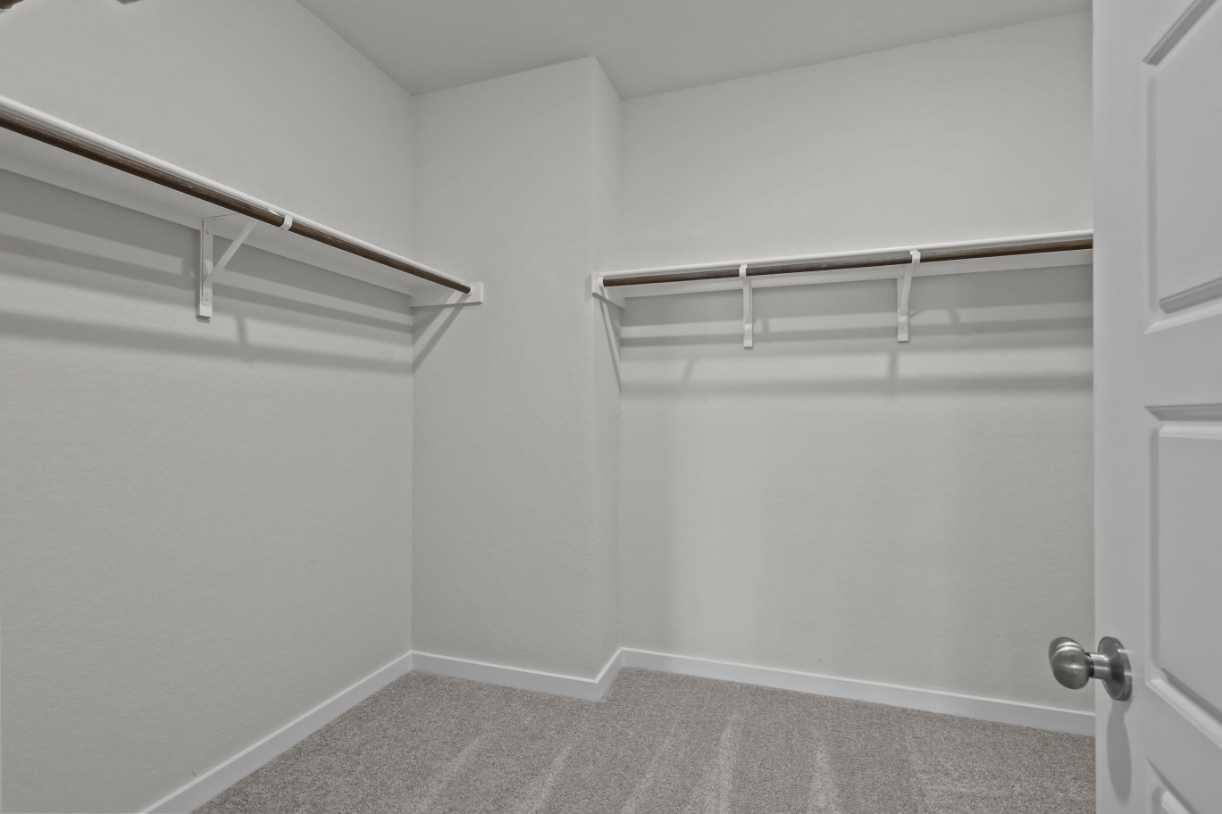 A white room with a metal railing.