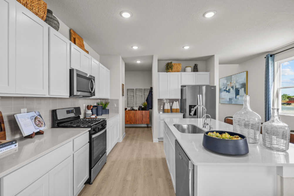 A kitchen with white cabinets.