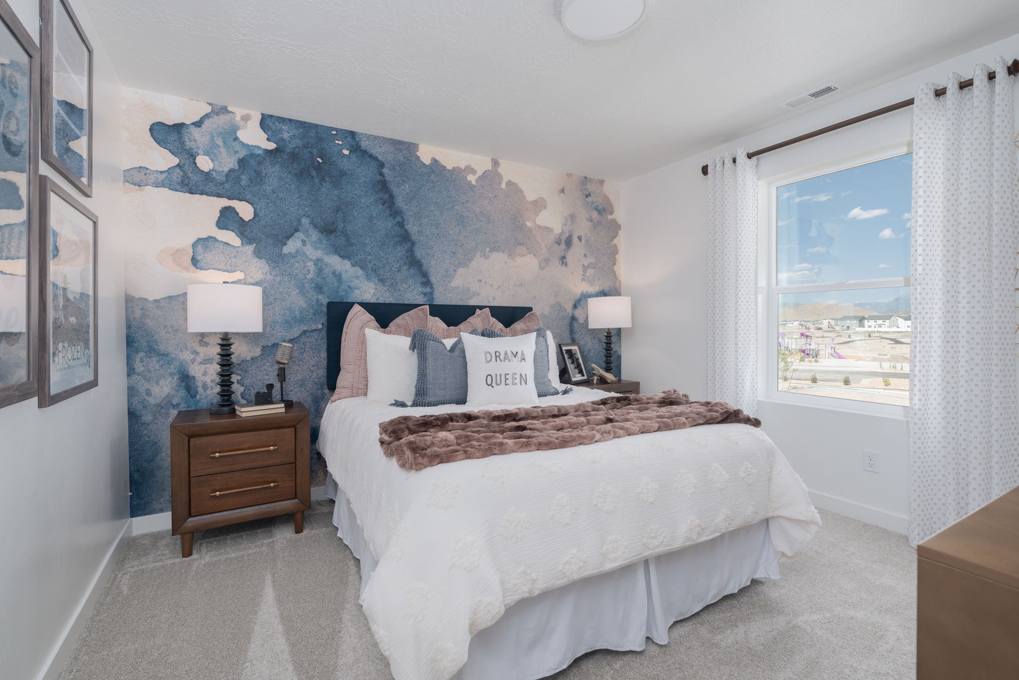A bedroom with a large blue wall.