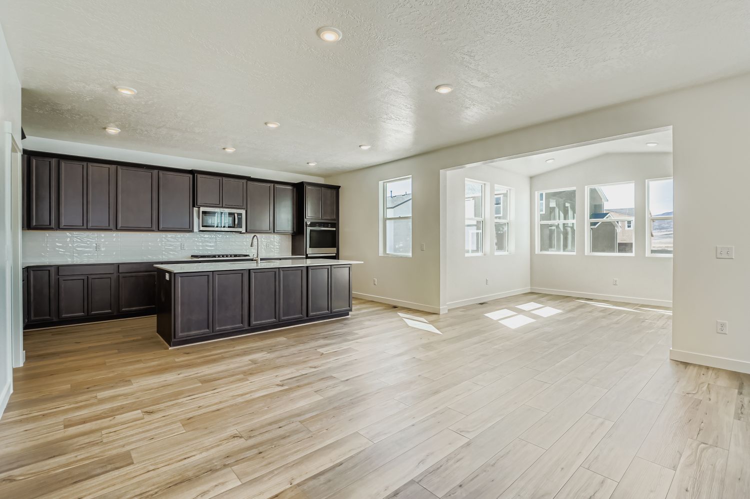 A large kitchen with black cabinets.