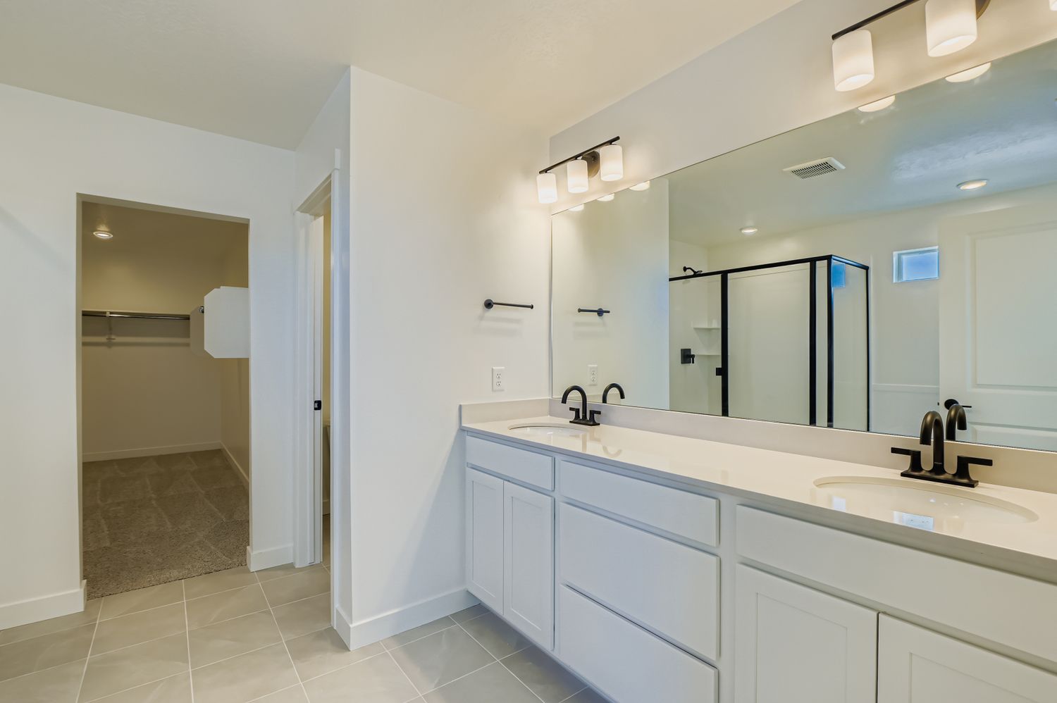 A bathroom with a large mirror.