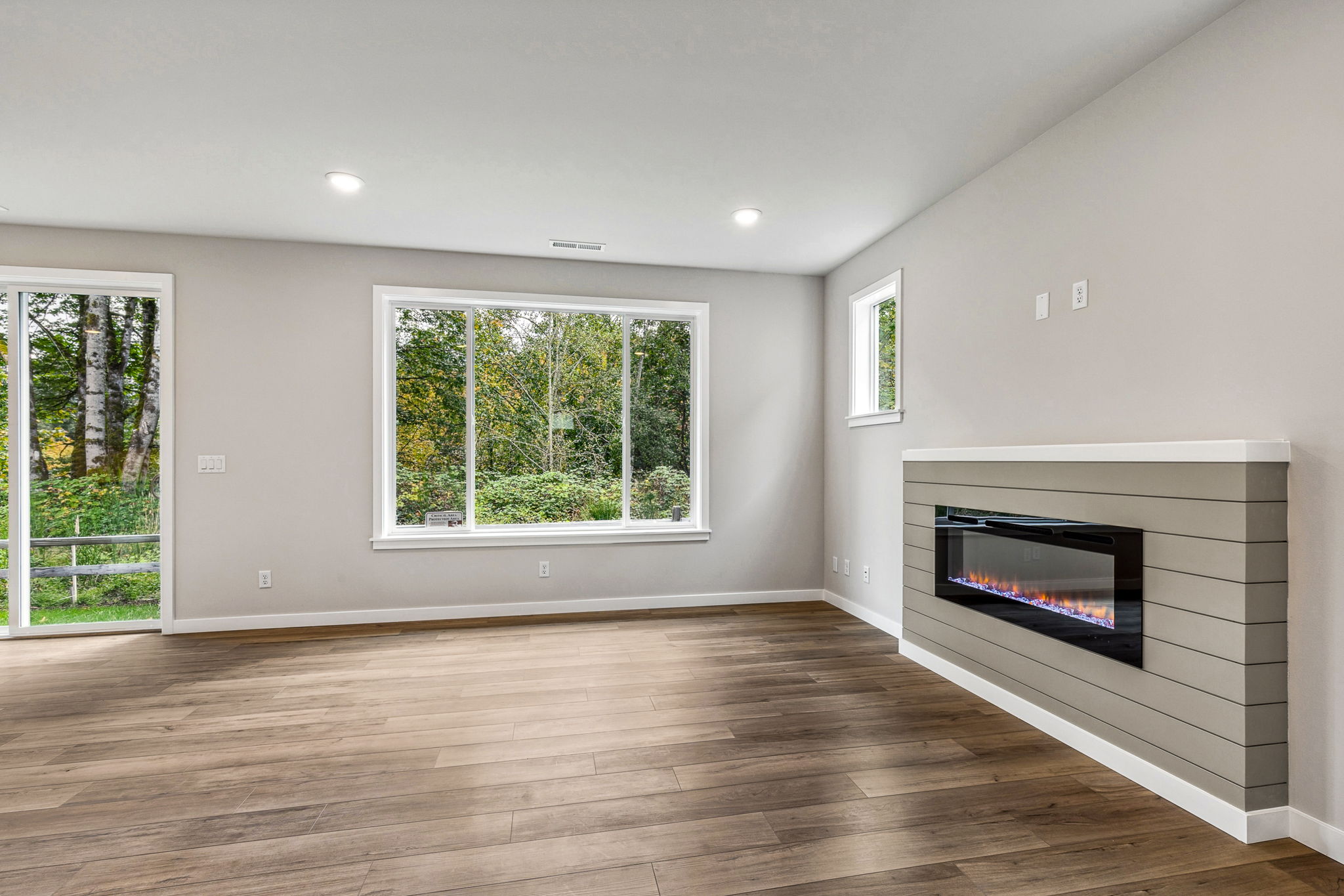 A room with a fireplace and a window.