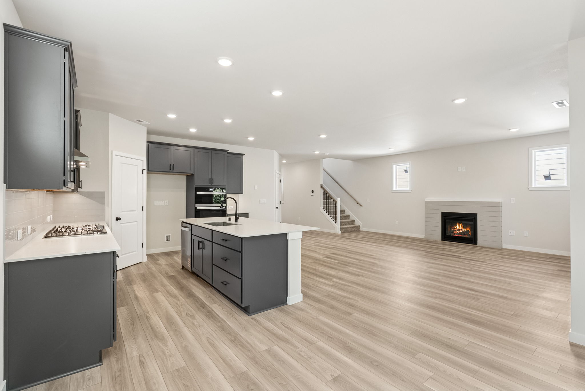 A large kitchen with black cabinets.