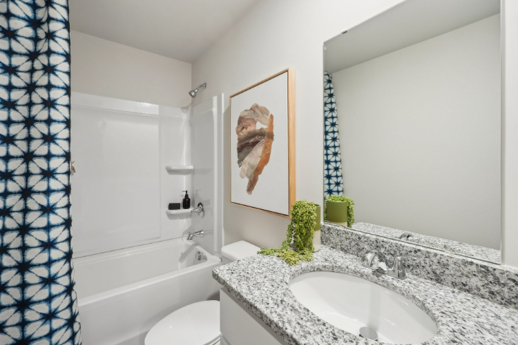A bathroom with a sink and a mirror.