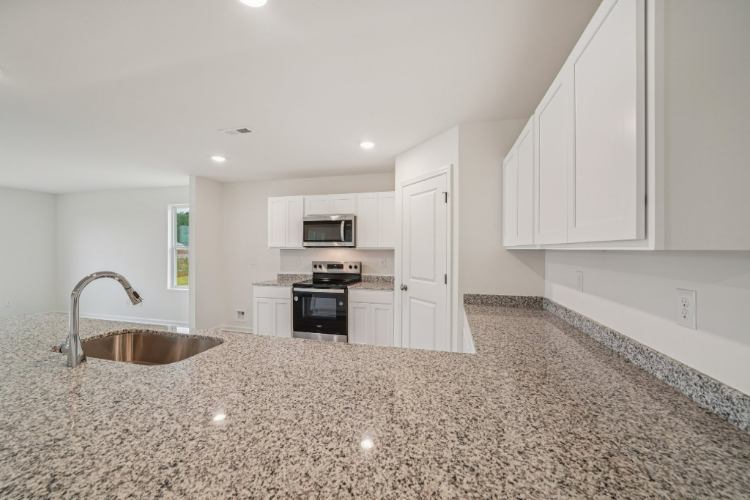 A kitchen with marble counters.