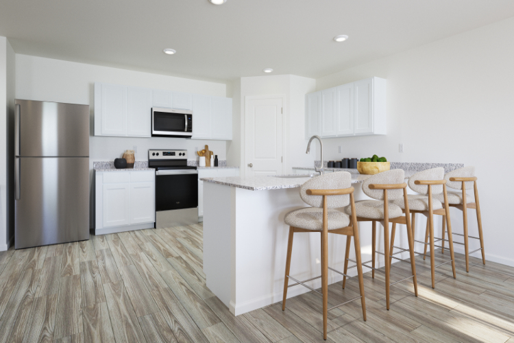 A kitchen with a table and chairs.