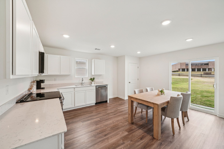 A kitchen with a dining table.