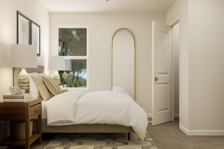 A bedroom with a bed and lamps.