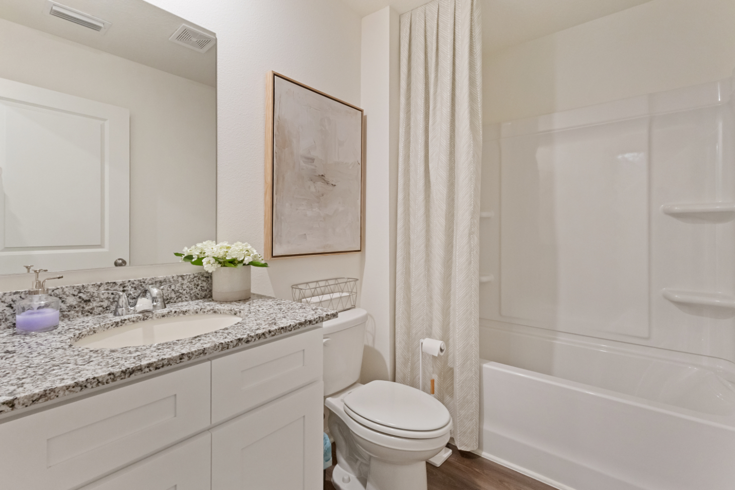 A bathroom with a tub sink and toilet.