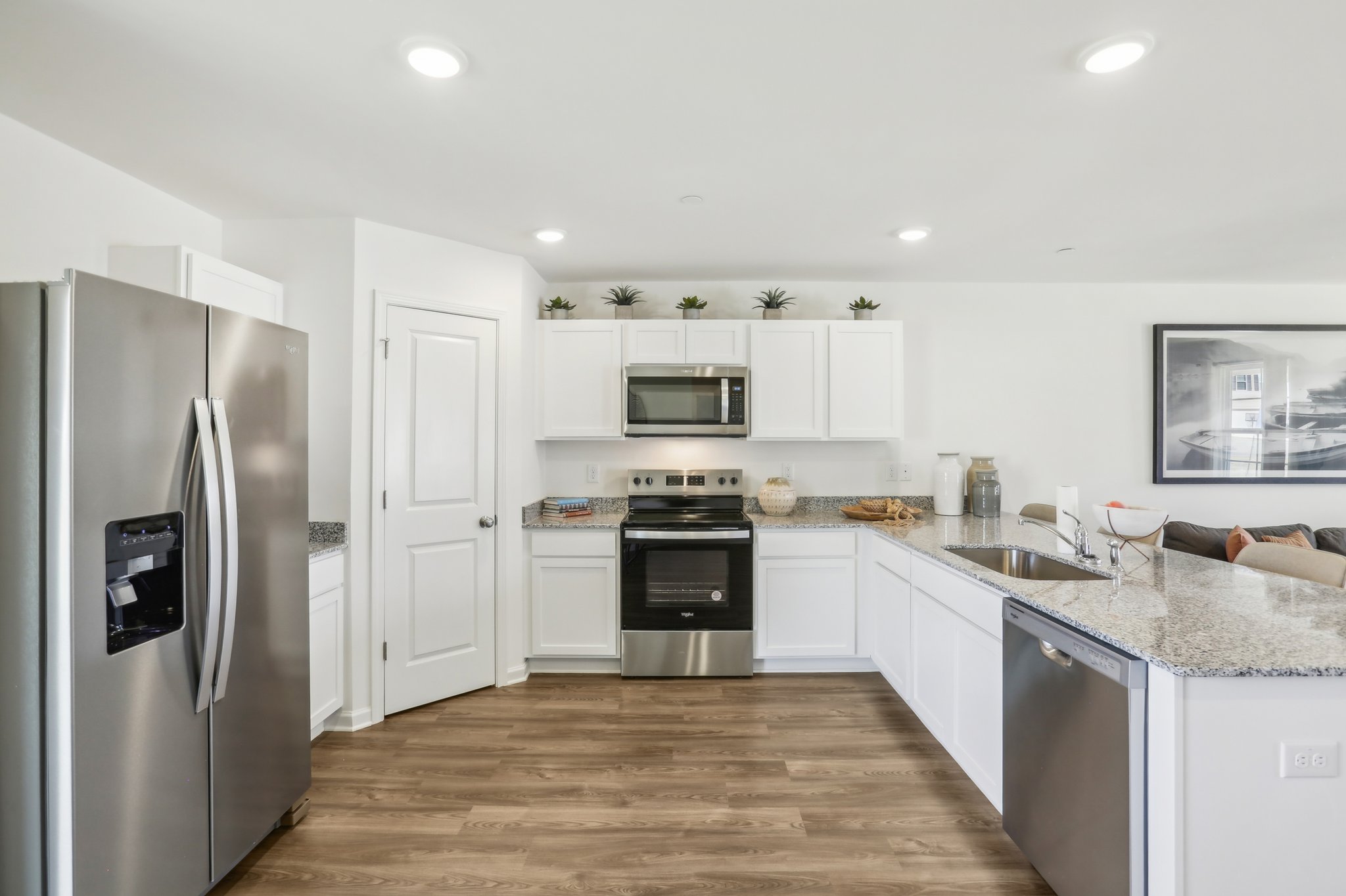 A kitchen with white cabinets.