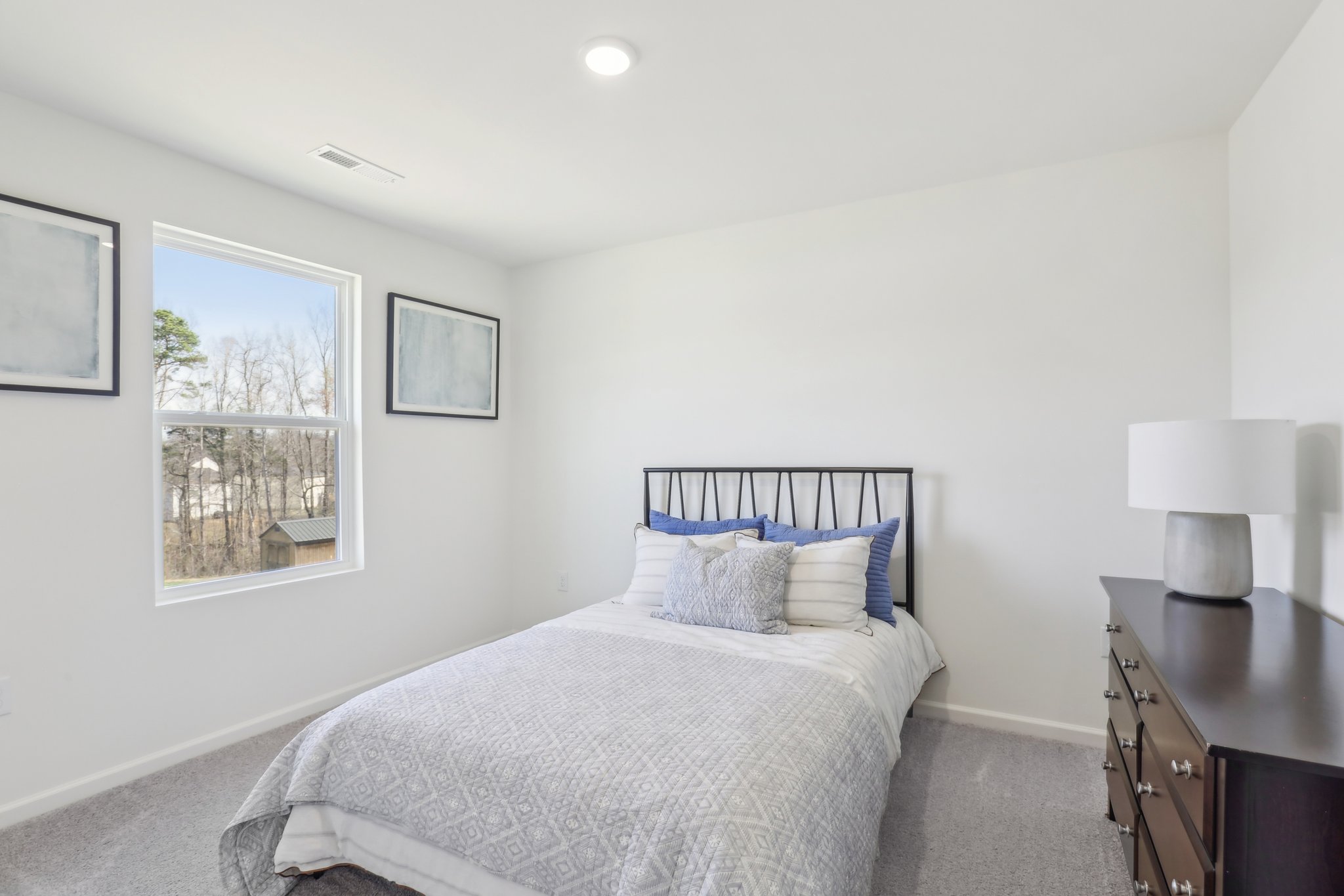 A bedroom with a bed and a window.